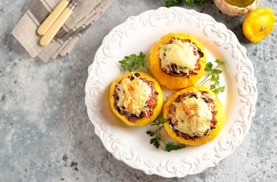 Organic yellow patissons stuffed with meat, onions, carrots, mushrooms and red pepper baked in the oven with cheese.
