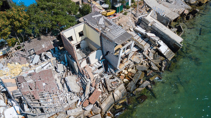 The destroyed house after the earthquake on the seashore