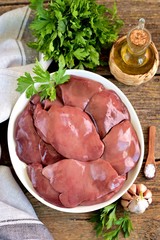 Fresh raw organics turkey liver on an old wooden background. Rustic food.