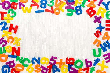 Colorful plastic numbers and letters as frame