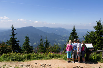 View and outlook from Lysa Hora, Beskid Mountains, Western Carpathians, Czech Republic / Czechia / Europe - young hikers and backpacers are looking from the top of the hill and mountain