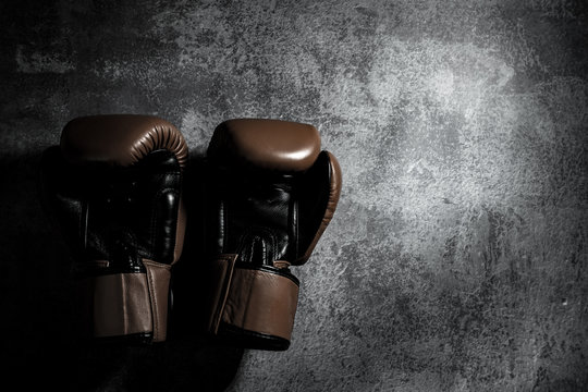 boxing gloves on texture background with copy space. Don&rsquo;t give up or defeat concept.