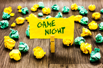 Writing note showing Game Night. Business photo showcasing event in which folks get together for the purpose of getting laid Clothespin holding yellow note paper crumpled papers several tries.