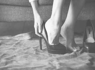 Woman putting on high heels