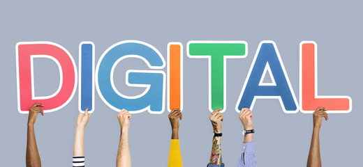 Hands holding up colorful letters forming the word digital