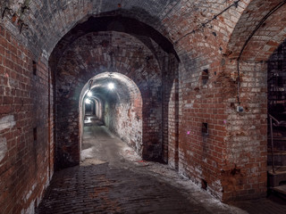 Kaliningrad, Russia - May, 2018. Long underground tunnel leading to the left with illumination.