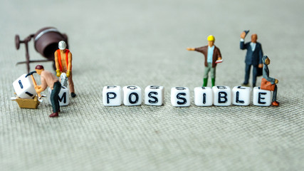 Removing white cubes with letters i and m of the word impossible creating new word possible on grey...
