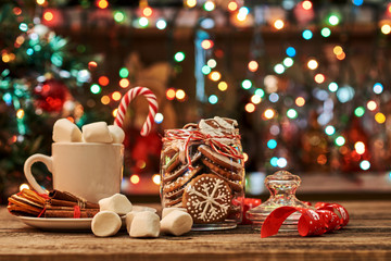 Christmas card composition with cacao, marshmallows, cinnamon, gingerbread, Christmas tree on dark...