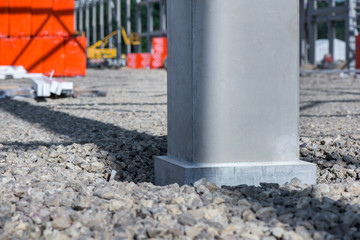 Fototapeta na wymiar Industrial construction site of new shopping mall in a city. Reinforced concrete piles foundation for the building. Freshly made grouting base pole for block building