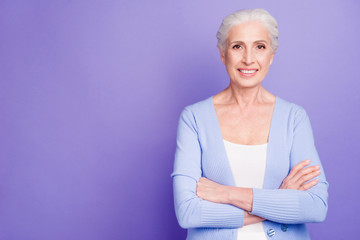 Portrait of confident elderly woman looking at camera with arms 