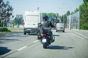 Vintage look abstract shot of black biker with motorcycle driving on highway. Road trip around Europe. Lonely traveler
