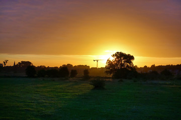 Fototapeta na wymiar Sunset over grass field