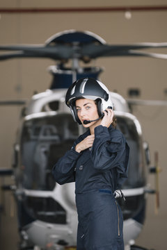 Pilot girl poses with her helicopter.