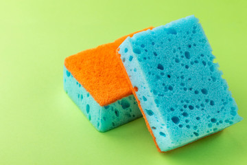 Sponges for dishwashing. Kitchen equipment. Green background