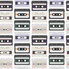 Obraz premium Vintage seamless pattern with analogue music cassettes. 80s Loopable background with magnetic audio tapes.