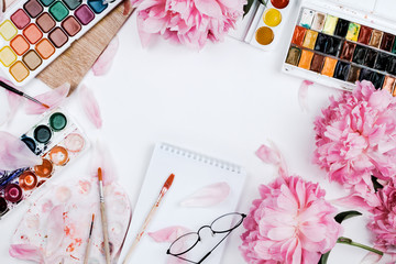 Obraz na płótnie Canvas Beautiful feminine flatlay mockup with notebook, stationery supplies, watercolors and pink peonies on white
