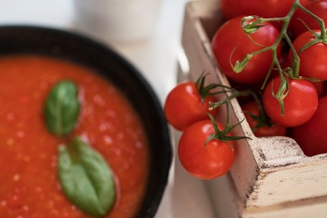 Tomato sauce ingredients. Cherry tomatoes, onion, basil, garlic, chili, pepper on the rustic table. Healthy food. Natural nutrition. Organic vegetables. Summer crops. Top view. Selective focus.