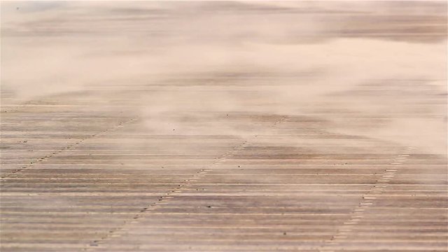 Wind blowing sand on empty beach