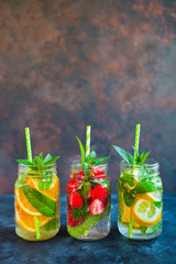 Fresh lemonade with mint, summer fruits and berries in mason jar. Copy space background