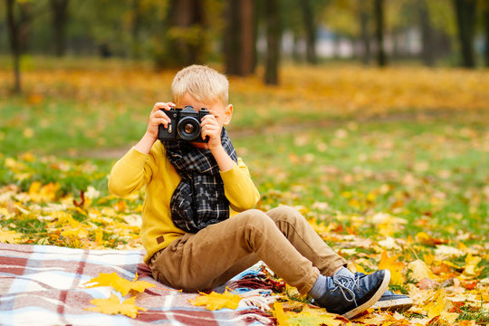 baby taking pictures, little boy taking pictures in autumn in nature