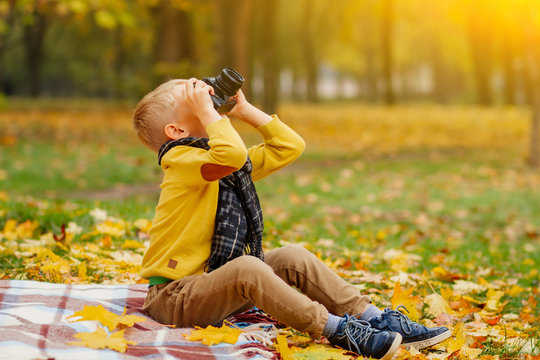 baby taking pictures, little boy taking pictures in autumn in nature