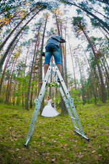 Wedding photographer using stepladder to make pictures of the bride