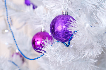 purple balls on  white Christmas tree