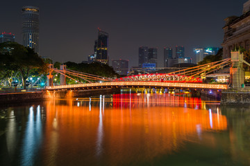 Fototapeta na wymiar Cavenagh Bridge over the Singapore River is one of the oldest bridges and the only cable stayed suspension bridge in Singapore