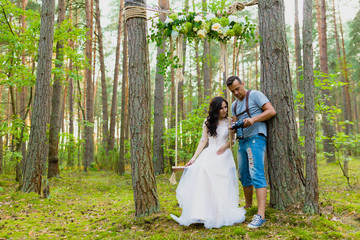 Photographer and bride watching recently taken photos
