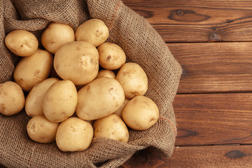 Pile of potatoes lying on wooden boards
