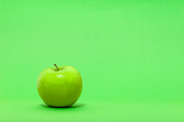 Fresh apple on green background
