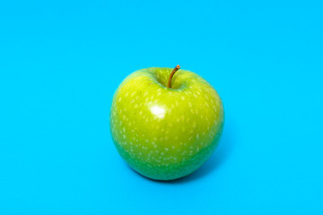 Fresh green apple isolated on blue background