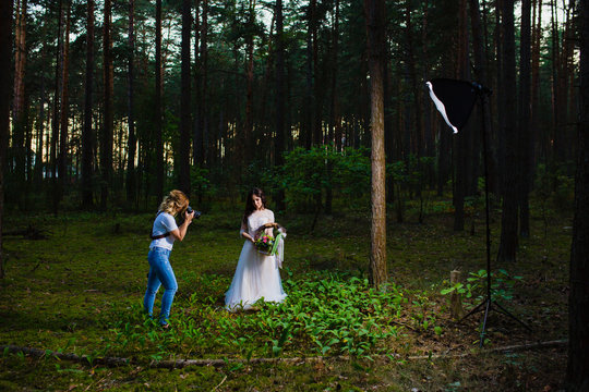 Professional wedding photographer using strobe and softbox to make pictures