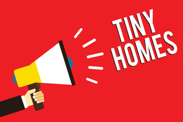 Word writing text Tiny Homes. Business concept for houses contain one room only or two and small entrance Cheap Man holding megaphone loudspeaker red background message speaking loud.