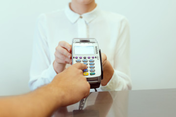 Guest at hotel reception paying with check during check-in