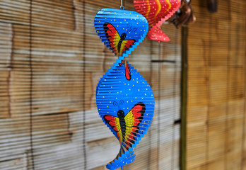 Handmade wooden carved souvenirs with weathered natural texture. Colorful gifts, nice memories of vacation. Souvenirs in art and craft  market. Selective focus and blurred background.