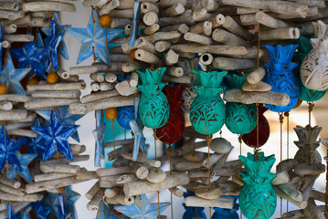 Colorful souvenir background. Souvenir shop selling souvenirs and handicrafts. Handmade wooden blue toy stars hanging in the shop. Sale of souvenirs with bright colorful patterned. Selective focus.