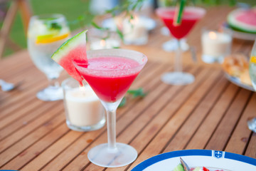 Family outdoor dinner in the garden in summer at sunset. Picnic food and drink concept