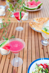 Family outdoor dinner in the garden in summer at sunset. Picnic food and drink concept