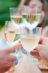 Family outdoor dinner in the garden in summer at sunset. Picnic food and drink concept