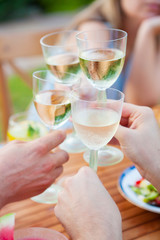 Family outdoor dinner in the garden in summer at sunset. Picnic food and drink concept