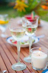Family outdoor dinner in the garden in summer at sunset. Picnic food and drink concept