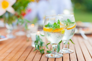 Family outdoor dinner in the garden in summer at sunset. Picnic food and drink concept