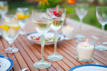 Family outdoor dinner in the garden in summer at sunset. Picnic food and drink concept