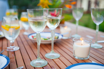 Family outdoor dinner in the garden in summer at sunset. Picnic food and drink concept