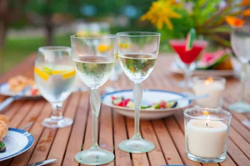 Foto op Aluminium Family outdoor dinner in the garden in summer at sunset. Picnic food and drink concept © yatcenko