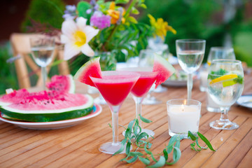Family outdoor dinner in the garden in summer at sunset. Picnic food and drink concept