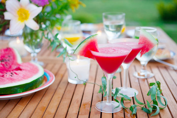 Family outdoor dinner in the garden in summer at sunset. Picnic food and drink concept