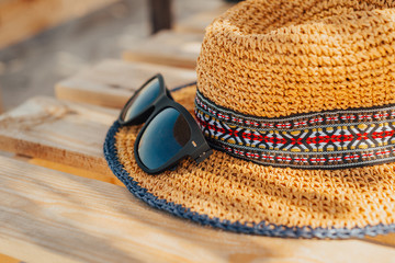 Finally a vacation. Sunglasses and straw women hat close-up