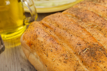 Pie with cabbage and mushrooms on a wooden background with ingredients.